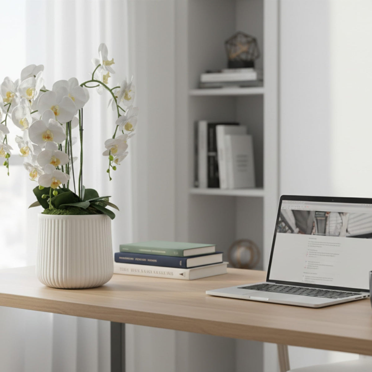 Crystal City Designs 28-inch artificial white Phalaenopsis orchid in a textured white pot on a wooden office desk.